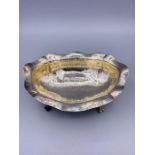 A Hammered silver bowl on claw feet, marked 800