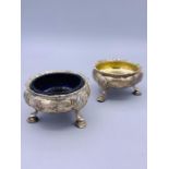 A Pair of silver cruets one with a blue glass liner. Makers Mark WC hallmarked London 1896.
