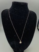 An 18ct white gold diamond set pendant necklace on gold chain 20 points approx