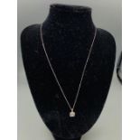 An 18ct white gold diamond set pendant necklace on gold chain 20 points approx
