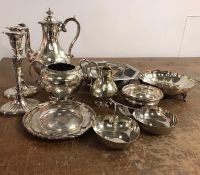 A large selection of silver plated items to include candlestick, coffee service and serving dishes.