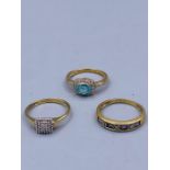 A selection of three 9ct gold rings with various settings.