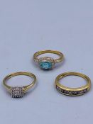 A selection of three 9ct gold rings with various settings.