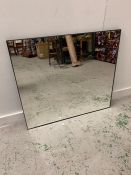 A square mirror with thin black metal frame