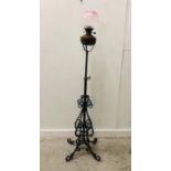 A Wrought Iron oil lamp base with burner and glass shade.