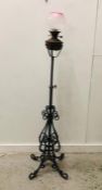 A Wrought Iron oil lamp base with burner and glass shade.