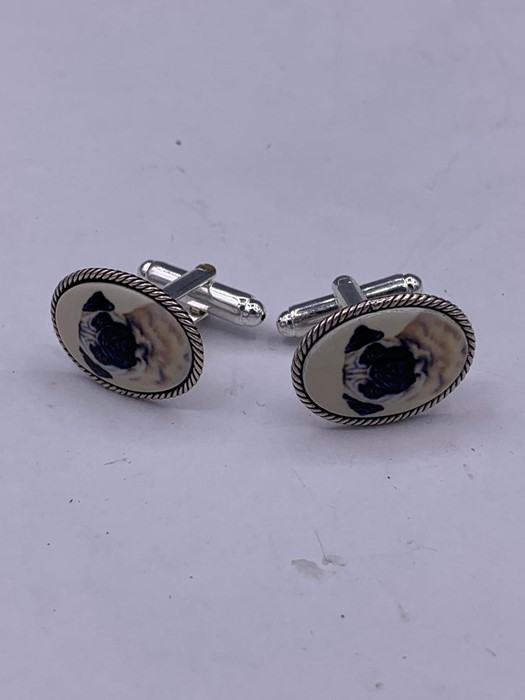 A pair of silver pictorial cufflinks depicting a dog