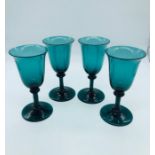 A set of Four dark green wine glasses C1770