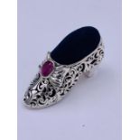 A substantial silver Victorian style shoe pincushion with ruby cabochon