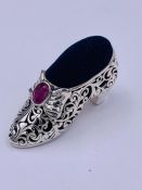 A substantial silver Victorian style shoe pincushion with ruby cabochon