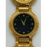 A Classic Gianni Versace Medusa coin watch in original box