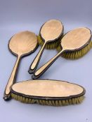 A silver dressing table to set to comprise three brushes and a hand mirror.