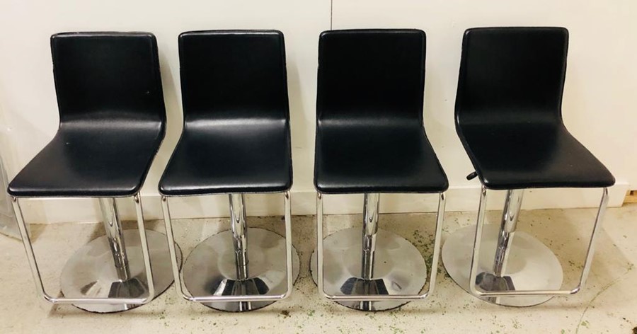 A set of Four Bar stools in black and chrome
