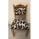 Six Oak craved back dining chairs with black and white seat covers