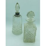 Two cut glass scent bottles, one with a silver collar