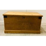 A Pine blanket box with drop handles and metal corners. 96 cm x 50cm x 50cm.