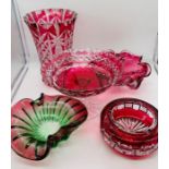 A selection of various Cranberry glass dishes and vases.
