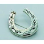 A Large Silver Horseshoe Shaped Brooch