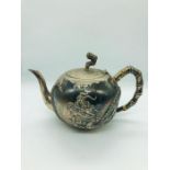 A Chinese Silver teapot by Hung Ching (1880 -1925) with dragon decoration (Handle AF) (725g)