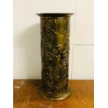 An ornate umbrella stand in brass.