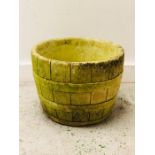 A Weathered Stone Half Barrell Planter