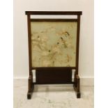 A Fire Screen with an inset Chinese silk panel.