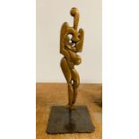 A Brass Abstract Sculpture on a Metal Stand