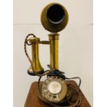 A Brass candlestick rotary telephone