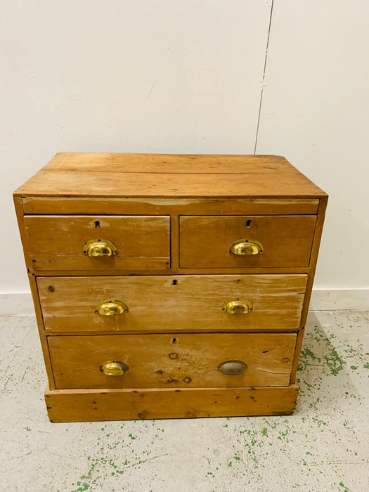 A Two over two pine chest of drawers with brass cup handles. - Image 2 of 4
