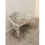A White wrought iron curved an ornate garden two seater bench