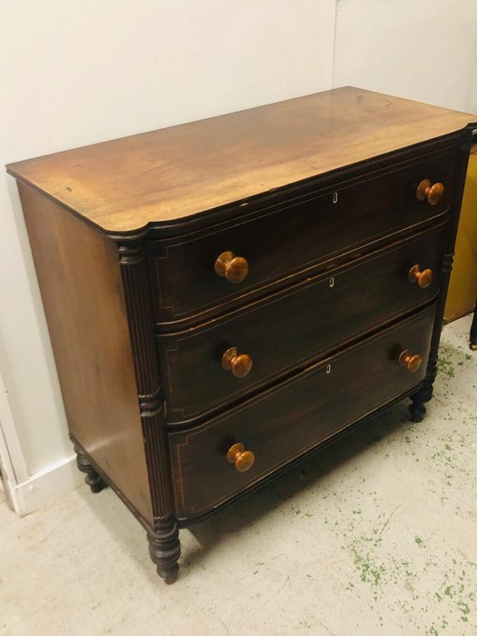 A Large three drawer chest with reeded column detailing. H 103 cm x 110cm W x 53cm D