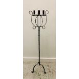 A cast iron three prong candle stick