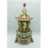 An Italian porcelain musical ornate carousel cigarette dispenser