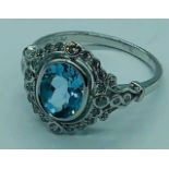 A Silver CZ and Large Central Blue Topaz Dress Ring