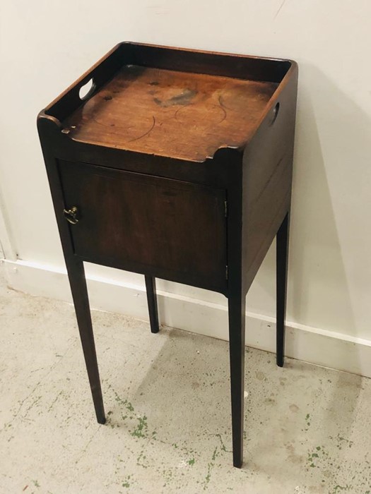 Pot cupboard on tapered legs with side handles.