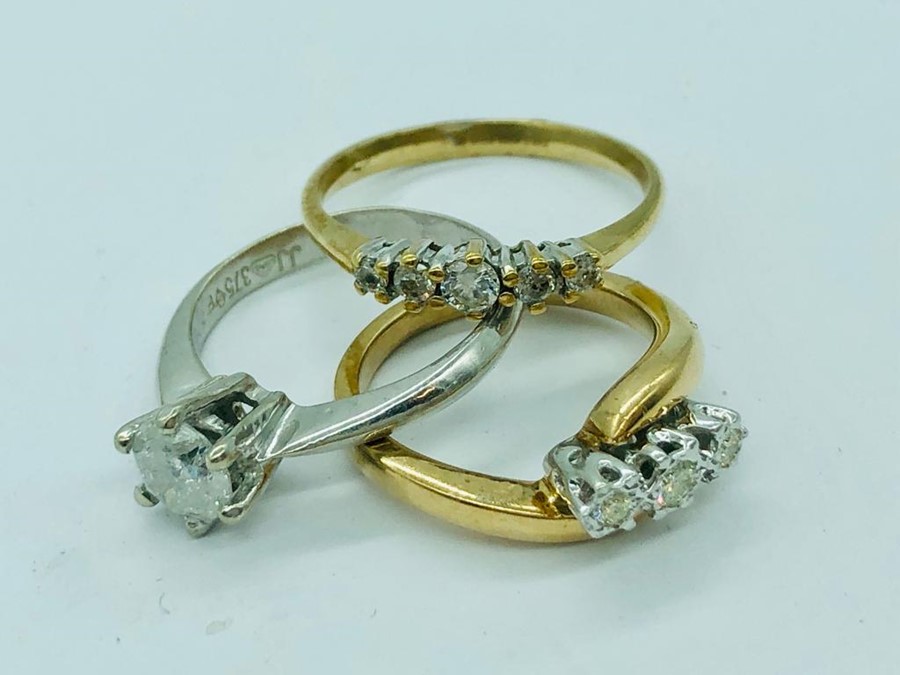 Three 9ct gold rings, various settings and stones (7.1g)