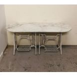 A Garden table with marble top and two singer sewing machine bases as legs H 74cm x W 167cm x D