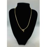 A Gold jointed 18ct necklace with central diamond of approximately 1 carat.