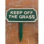 A wooden 'Keep off the Grass' sign.