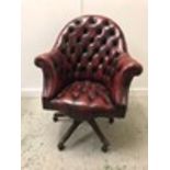 An Ox Blood Chesterfield style Captain chair