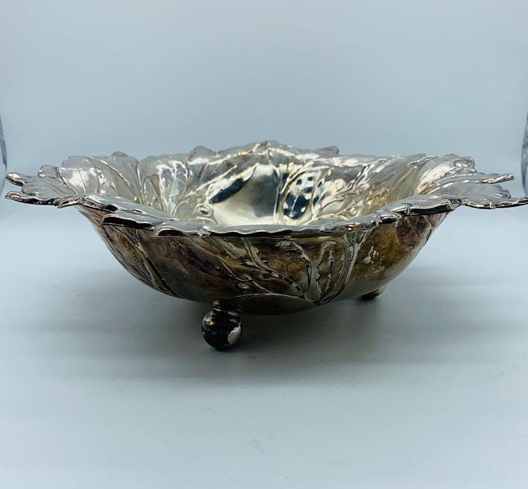A White metal bowl on three feet