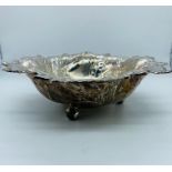 A White metal bowl on three feet