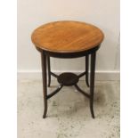 An occasional table with decorative inlay on four fluted legs with a lower galleried shelf H 69cm
