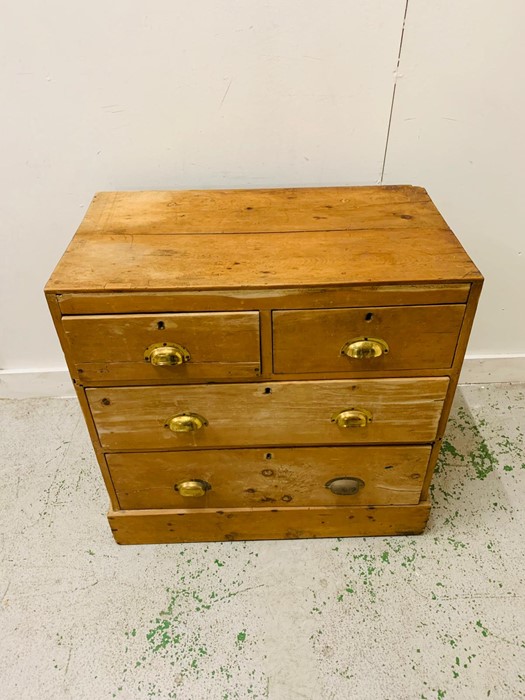 A Two over two pine chest of drawers with brass cup handles. - Image 3 of 4