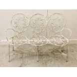 A White painted wrought iron three seater garden bench.