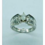 A white gold single stone ring with graduated shoulders.