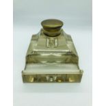 A glass inkwell with inset liner.