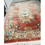 A Large Chinese rug with floral theme and tassled edge 246cm x 342cm