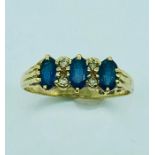 A Sapphire Three Stone Ring In 9ct Yellow Gold Setting