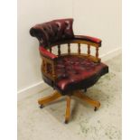 A Red Burgundy Leather swivel Captains Chair